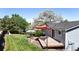 Aerial view of backyard with lush lawn, patio shade and vibrant greenery at 10950 Tennyson Ct, Westminster, CO 80031