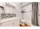 Bright bathroom featuring a shower and tub combination, mosaic tile accent, modern lighting, and white cabinetry at 10950 Tennyson Ct, Westminster, CO 80031