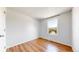 An uncluttered bedroom space with hardwood floors and a sunny window providing ample natural light at 10950 Tennyson Ct, Westminster, CO 80031