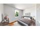 Cozy bedroom with a large window, hardwood floors, neutral walls, and a comfortable bed with stylish bedding at 10950 Tennyson Ct, Westminster, CO 80031