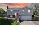 Charming two-story home featuring a red front door, well-manicured lawn, and blooming trees creating curb appeal at 10950 Tennyson Ct, Westminster, CO 80031