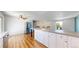 Modern kitchen with a center island, stainless steel refrigerator, and stylish overhead lighting at 10950 Tennyson Ct, Westminster, CO 80031