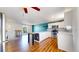 Open-concept kitchen featuring white cabinetry, stainless steel appliances, and an eat-in dining area at 10950 Tennyson Ct, Westminster, CO 80031