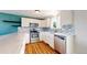 Beautifully renovated kitchen featuring white cabinets, a stylish backsplash, and stainless steel appliances at 10950 Tennyson Ct, Westminster, CO 80031
