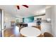 Open-concept kitchen featuring white cabinetry, stainless steel appliances, and an eat-in dining area at 10950 Tennyson Ct, Westminster, CO 80031