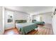Serene main bedroom featuring hardwood floors, ample closet space, and a bright, airy atmosphere at 10950 Tennyson Ct, Westminster, CO 80031