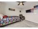 This cozy bedroom features carpet, a ceiling fan, and room for an armchair and television at 23545 E Platte Dr # C, Aurora, CO 80016