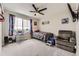 bedroom with large window, carpeted floor, ceiling fan, and a TV at 23545 E Platte Dr # C, Aurora, CO 80016