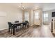 Dining room featuring a black table, stylish chairs, wood floors, and abundant natural light at 23545 E Platte Dr # C, Aurora, CO 80016