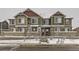 View of a townhome's exterior showcasing its inviting facade, enhanced by the surrounding winter landscape at 23545 E Platte Dr # C, Aurora, CO 80016