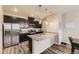 Modern kitchen features stainless steel appliances, granite countertops, and a large island with pendant lighting at 23545 E Platte Dr # C, Aurora, CO 80016