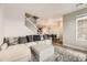 Open-concept living room featuring a comfortable gray sectional, staircase, and adjacent dining area at 23545 E Platte Dr # C, Aurora, CO 80016