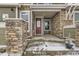 Inviting front porch with stone pillars, a red door, and a charming potted plant at 23545 E Platte Dr # C, Aurora, CO 80016