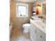 A charming bathroom offers a white vanity, neutral tiling, natural light, and an updated design at 401 S Williams St, Denver, CO 80209