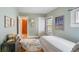 Bright bedroom with a vintage chest of drawers and colorful accents at 401 S Williams St, Denver, CO 80209