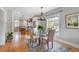 Bright dining area with a glass table, modern chandelier, and hardwood floors at 401 S Williams St, Denver, CO 80209