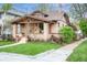 Charming home featuring a manicured lawn, mature trees, and inviting front porch at 401 S Williams St, Denver, CO 80209