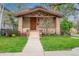 Craftsman-style bungalow with a welcoming front porch, brick accents, and a well-maintained lawn at 401 S Williams St, Denver, CO 80209