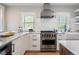 This kitchen features stainless steel appliances, white cabinets, marble countertops and subway tile backsplash at 401 S Williams St, Denver, CO 80209