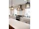 Well-lit kitchen featuring white cabinets, stainless steel range, and farmhouse sink at 401 S Williams St, Denver, CO 80209
