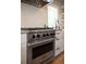Close-up of a Viking stainless steel range with a white subway tile backsplash at 401 S Williams St, Denver, CO 80209