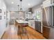 Modern kitchen with white cabinets, a center island, stainless steel appliances, and hardwood floors at 401 S Williams St, Denver, CO 80209