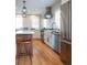 Beautiful kitchen features stainless steel appliances, center island with seating, and hardwood floors at 401 S Williams St, Denver, CO 80209
