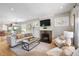 Cozy living room with brick fireplace, hardwood floors, and comfortable seating area at 401 S Williams St, Denver, CO 80209