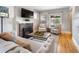 Comfortable living room with a brick fireplace, hardwood floors, and a neutral color palette at 401 S Williams St, Denver, CO 80209