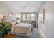 Cozy main bedroom with hardwood floors, plush bedding, a large window, and elegant decor at 401 S Williams St, Denver, CO 80209
