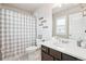 Bright bathroom featuring a vanity with storage and a shower with a curtain at 2395 S Troy Ct, Aurora, CO 80014