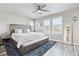 Spacious bedroom with large bed, bench with drawers, and multiple windows at 2395 S Troy Ct, Aurora, CO 80014