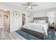 Bedroom features a large bed, ceiling fan, and access to en-suite bathroom at 2395 S Troy Ct, Aurora, CO 80014