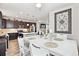 Open concept view of a dining room and kitchen area in a house, showing the appliances, island and kitchen table at 2395 S Troy Ct, Aurora, CO 80014