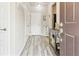 Bright entryway featuring wood-look flooring, a white front door, and a stylish console table as you enter at 2395 S Troy Ct, Aurora, CO 80014