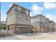 Modern townhome exterior with brick and siding and attached garages at 2395 S Troy Ct, Aurora, CO 80014