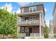 Charming two-story home with a brick facade and a welcoming front porch on both the first and second level at 2395 S Troy Ct, Aurora, CO 80014