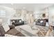 Spacious living room with comfortable seating, neutral decor, and a seamless transition into the kitchen area at 2395 S Troy Ct, Aurora, CO 80014