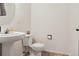 Clean bathroom with pedestal sink and toilet at 4452 S Auckland Ct, Aurora, CO 80015