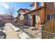 Townhouse exterior with walkway, snow, and fenced entry at 4452 S Auckland Ct, Aurora, CO 80015