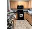 Kitchen features granite countertops and black appliances at 4452 S Auckland Ct, Aurora, CO 80015