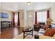 Living room with couches, wood floors, and a coffee table at 4452 S Auckland Ct, Aurora, CO 80015