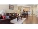 Living room with leather couches, wood floors, and dining area at 4452 S Auckland Ct, Aurora, CO 80015