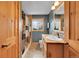 Bathroom featuring wood accents, a shower with a patterned curtain, and a sink at 10436 Jeanette Ct, Morrison, CO 80465