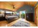 Bedroom with wood floors, a large bed, and access to a balcony at 10436 Jeanette Ct, Morrison, CO 80465
