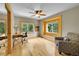 A bright and airy bedroom featuring hardwood floors, large windows, and a ceiling fan at 10436 Jeanette Ct, Morrison, CO 80465