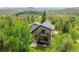 A charming home featuring a cozy balcony nestled amongst lush trees for a serene and private setting at 10436 Jeanette Ct, Morrison, CO 80465