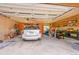 Spacious garage with a parked car and ample storage space at 10436 Jeanette Ct, Morrison, CO 80465