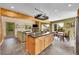 An open layout kitchen, dining, and living room area with center island and hardwood floors at 10436 Jeanette Ct, Morrison, CO 80465