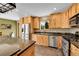 Modern kitchen features stainless steel appliances, custom cabinets, and granite countertops at 10436 Jeanette Ct, Morrison, CO 80465